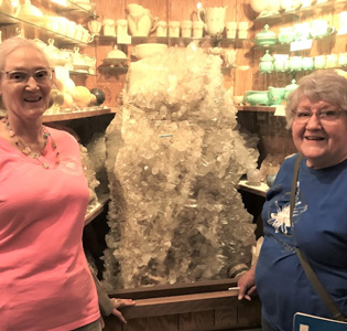 ladies by a large geode in a store